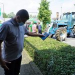 Farmers protest milk prices by bringing tractors to supermarket