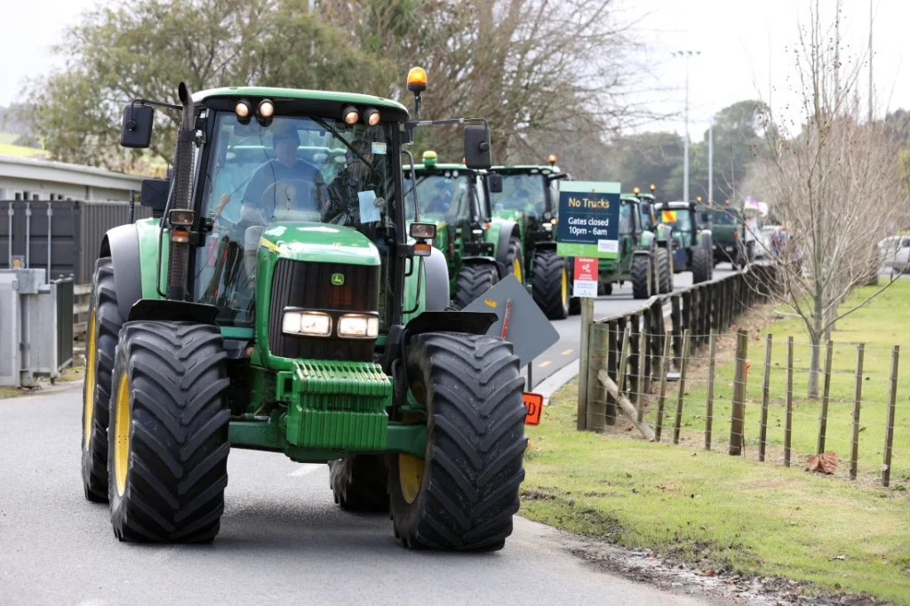 Farmers in a protest convoy against emissions-reduction policies drive through Warkworth, near Auckland in New Zealand. Getty