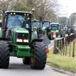 Farmers in a protest convoy against emissions-reduction policies drive through Warkworth, near Auckland in New Zealand. Getty