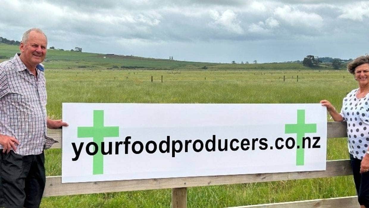 SUPPLIEDWaikato sheep and beef farmers Bruce and Yvonne Cameron with one of the group’s signs.