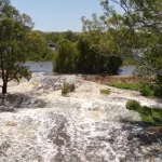 Water flowing through the levee breach at Wall Flat.