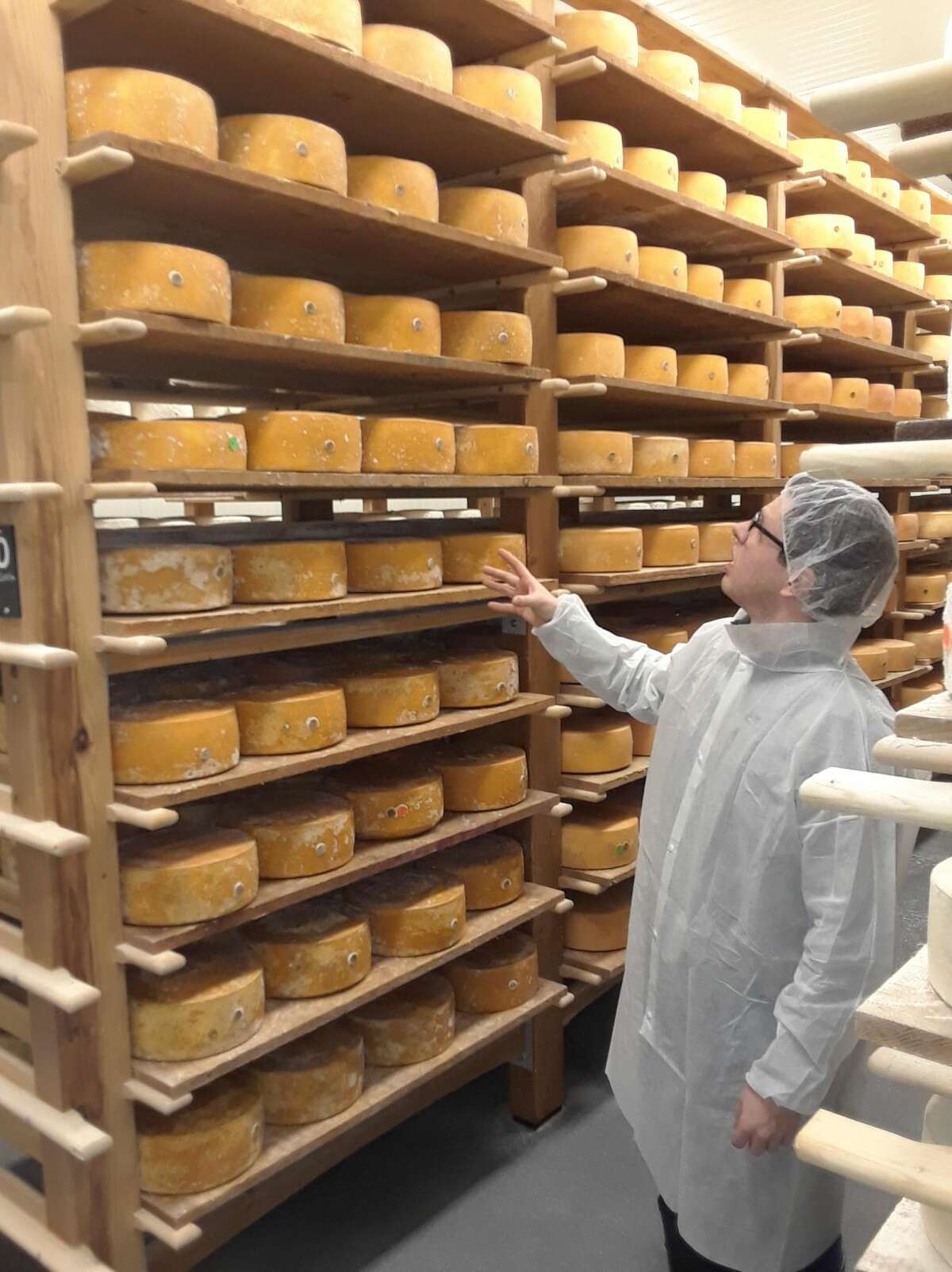 Arethusa's cheesemaker Matt Benham leads a tour inside one of the dairy's cheese caves, a chilled room where the prize-winning blue cheese ripens before it's ready to be sold.