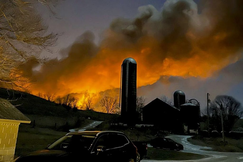 Billows of smoke, lit orange by the flames from the derailed train, over a village in Ohio on February 3. Photo: AP