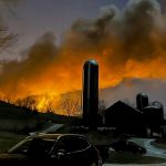 Billows of smoke, lit orange by the flames from the derailed train, over a village in Ohio on February 3. Photo: AP