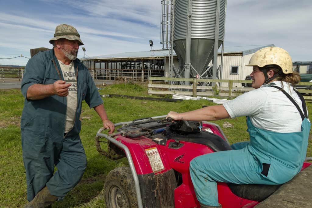 Stuart talking to farm assistant Charlotte Procter before she brings the herd in for milking Charlotte won the Taranaki Dairy Trainee of the Year 2023 Emerging Talent Merit Award.