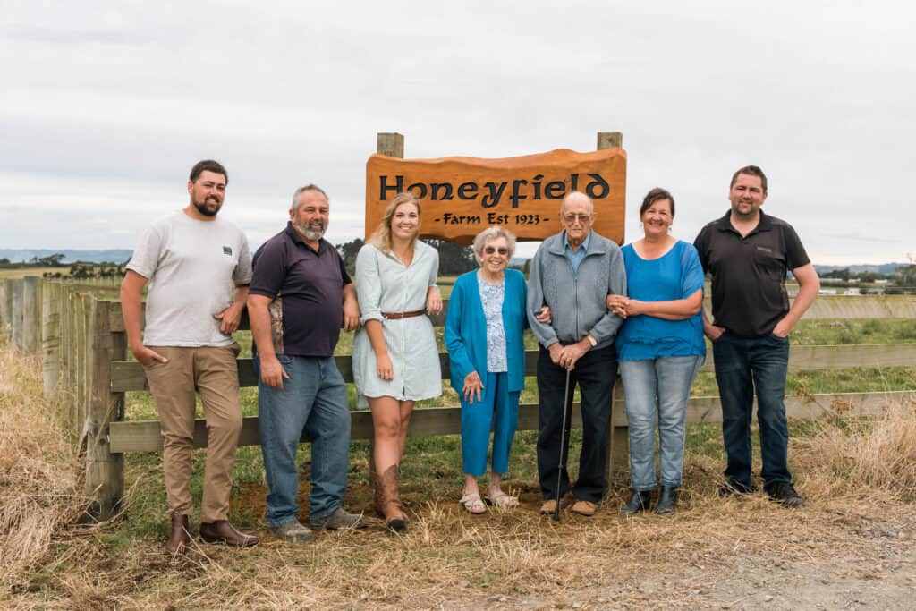 This year, the farm will achieve century status having been bought in 1923 by Stuart’s grandfather. Three generations of the Honeyfield family at the entrance to the farm. From left, son Scott, Stuart, daughter Rebecca, Elma and Barry Honeyfield (Stuart’s parents), Delwyn, and son Troy.