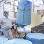 A barrel of cheese is brought in to be processed into American cheese at the Bongards location in Norwood, Minnesota