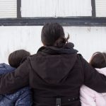 Lupita, who we’re only identifying by her middle name due to her legal status, stands for a portrait with her kids in Addison County. She left Mexico more than a decade ago to work on Vermont dairy farms.