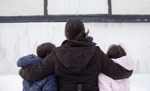 Lupita, who we’re only identifying by her middle name due to her legal status, stands for a portrait with her kids in Addison County. She left Mexico more than a decade ago to work on Vermont dairy farms.